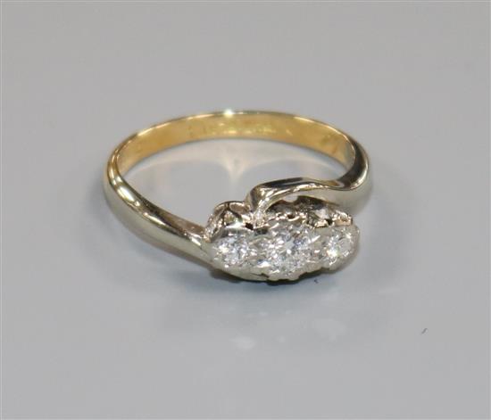 An 18ct gold, platinum and illusion set three stone diamond ring, size G.